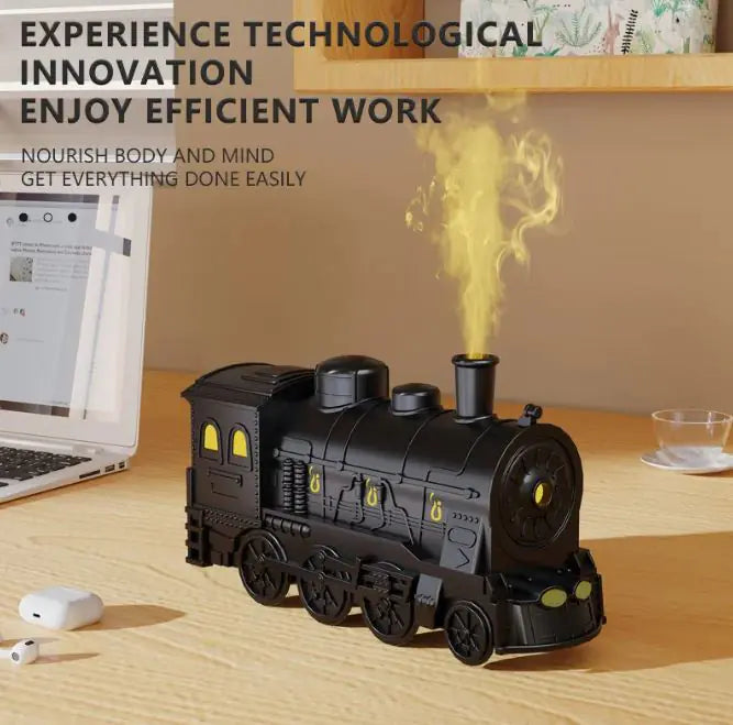 Black train-shaped diffuser emitting steam on a desk with text about technological innovation and efficiency.